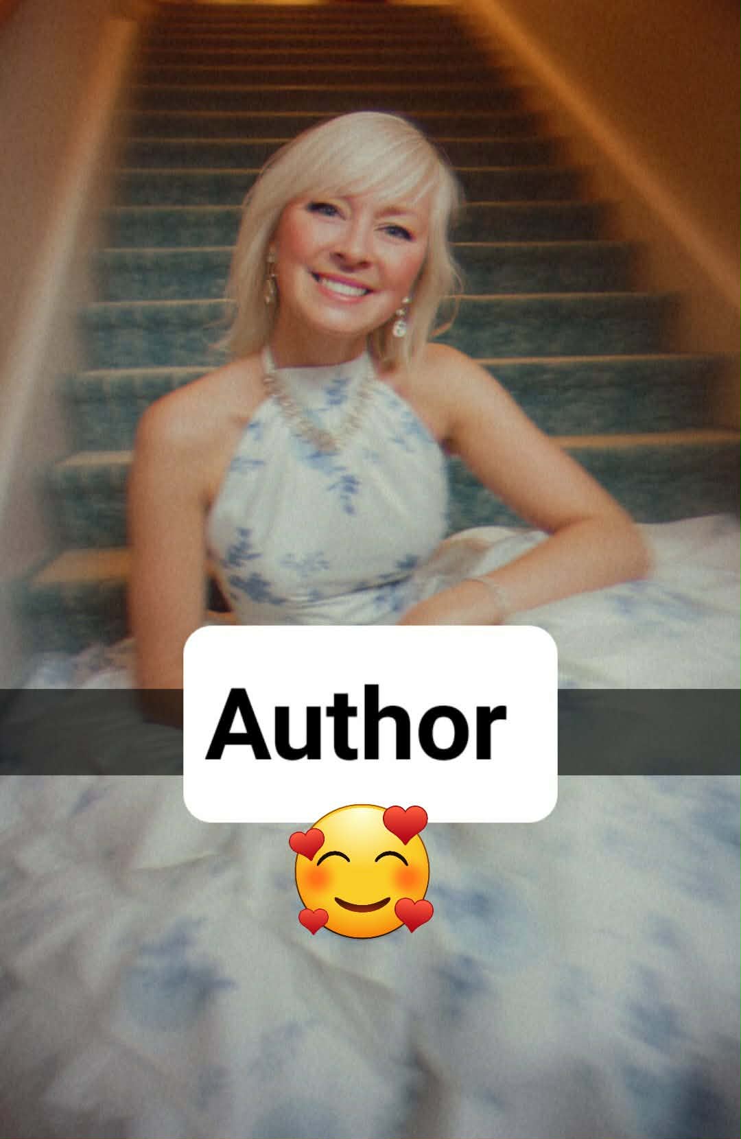 Woman in a white and blue floral dress sits on carpeted stairs, smiling. The word "Author" with a smiling emoji is overlaid on the image.